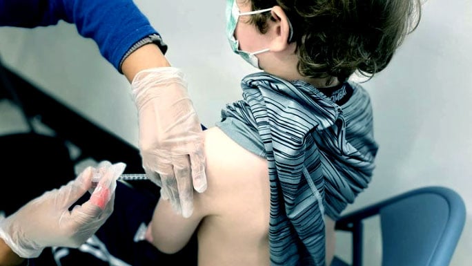 A child gets the Pfizer-BioNTech COVID-19 Vaccine (Photo by Nate Ivey. Licensed under CC BY-SA 4.0. Cropped, contrast increased, and colorized from the original.)